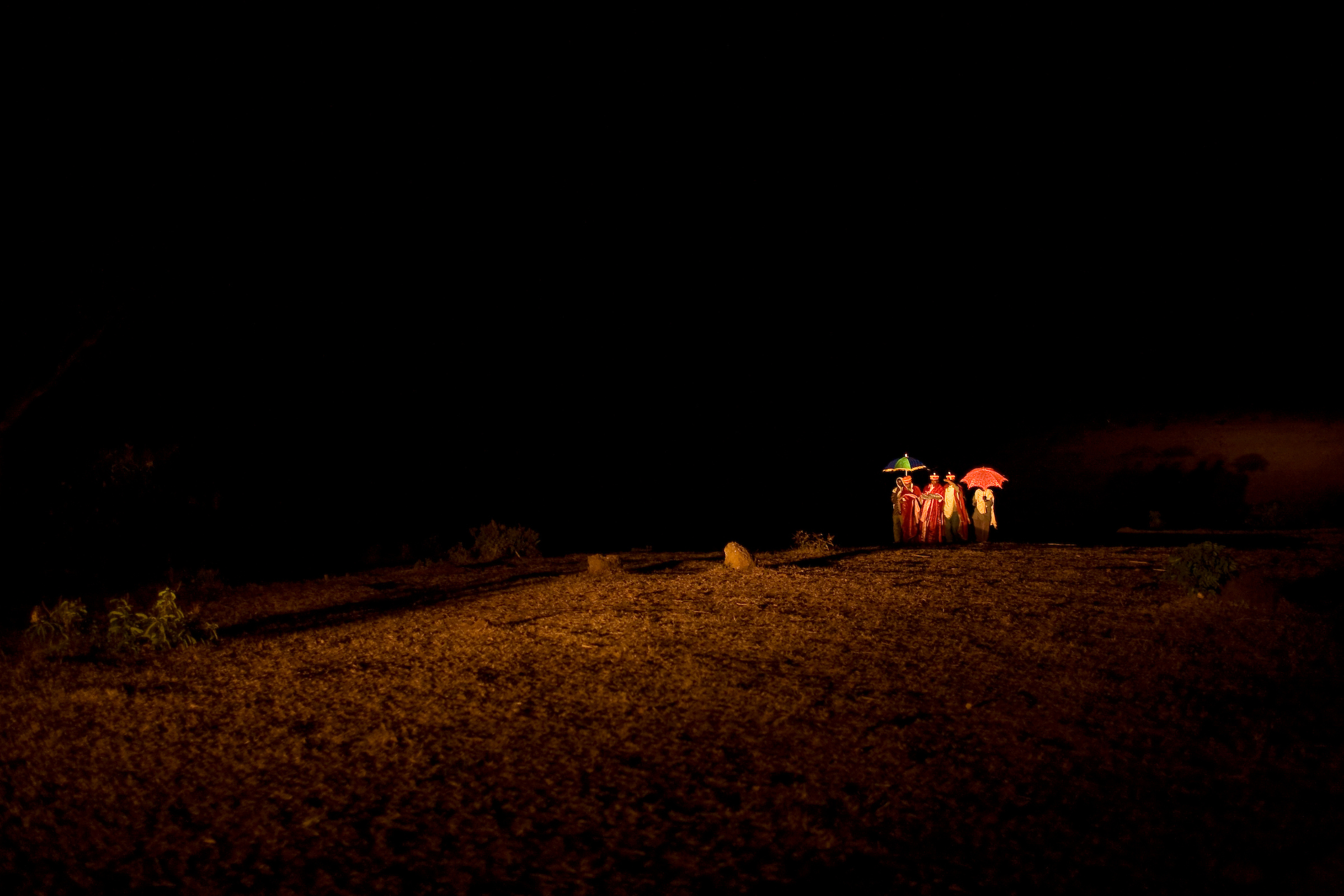 As per religious tradition, Addisu, 23, walks with fellow priests to retrieve his new bride on the evening before his wedding day.