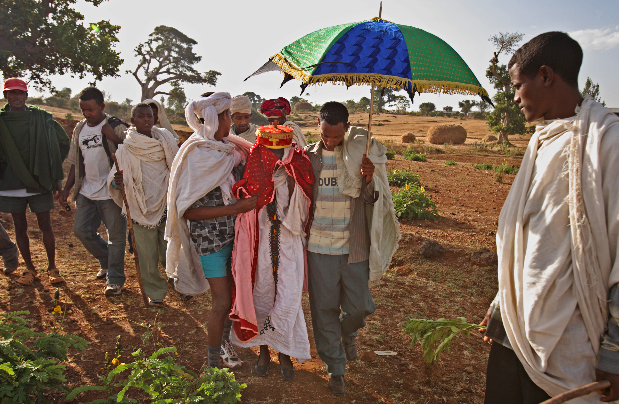 Escorted and encouraged by the wedding party, new bride Destaye, 11, reluctantly approaches the home of her new husband.