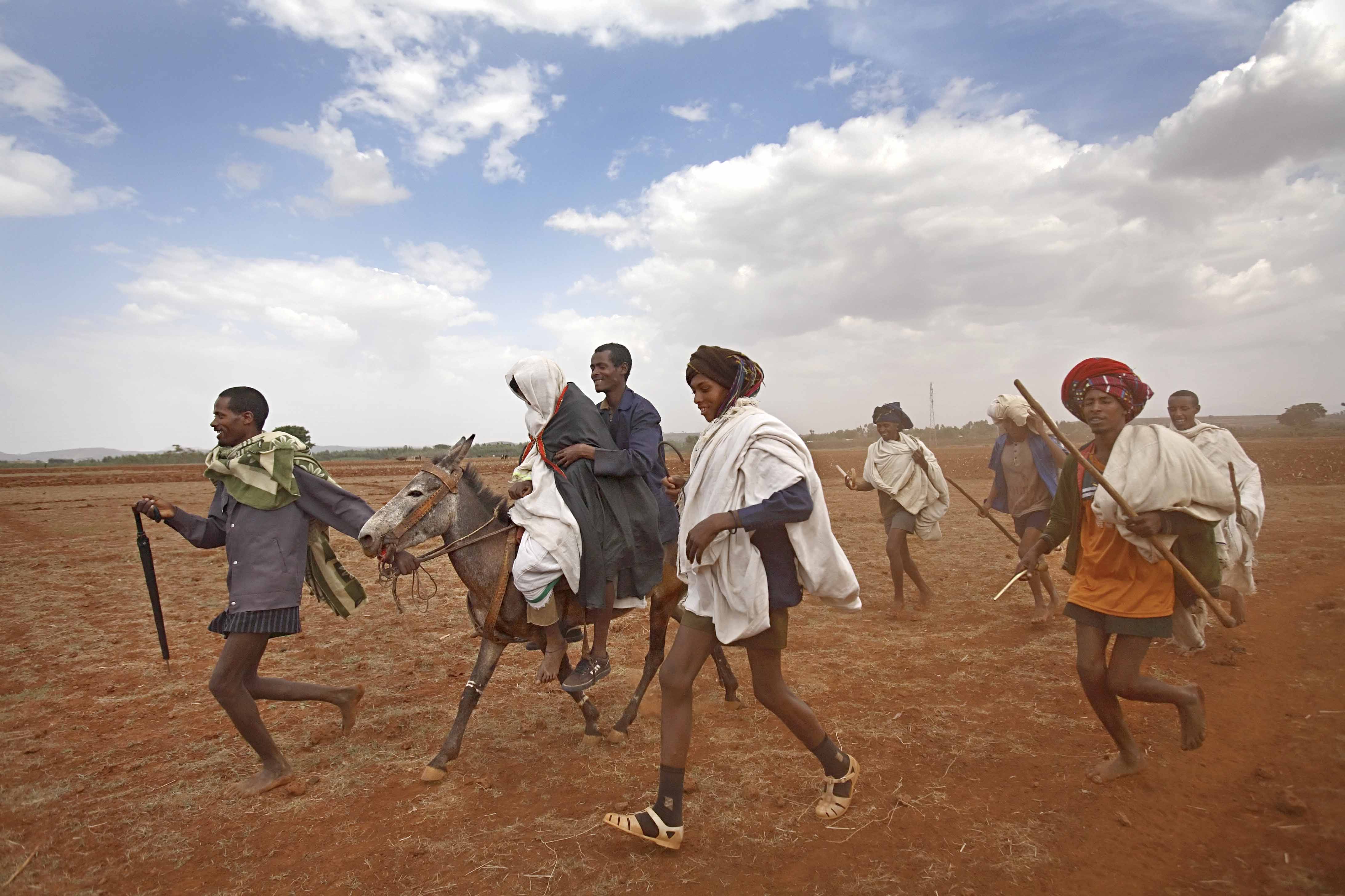 Leyualem, 14, is transported by mule to her new home. The men later said the cloth was placed over her head so she would not be able to find her way back home, should she want to escape the marriage.